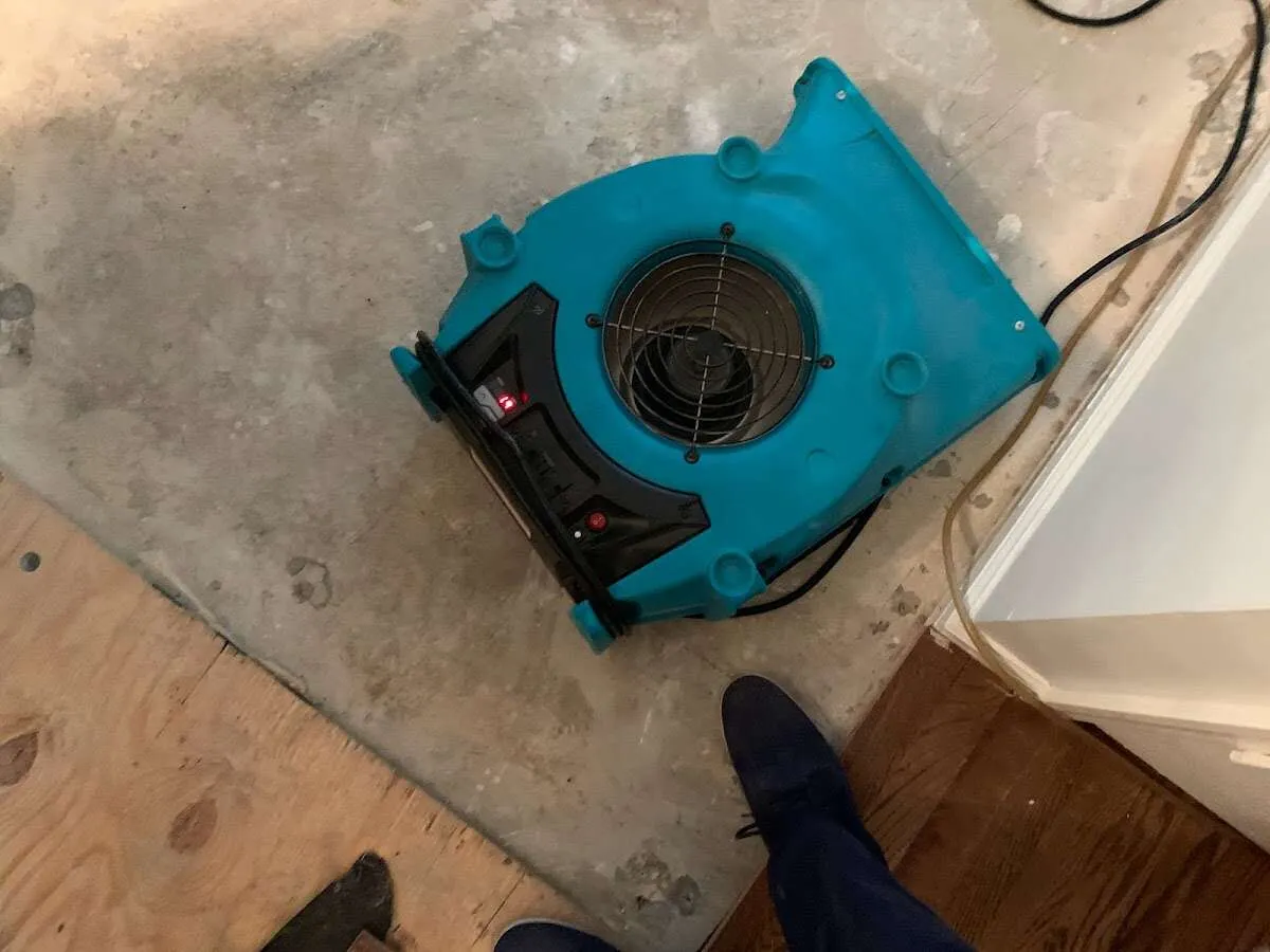 Air mover drying subfloor during Commercial Water Damage Restoration in Ballenger Creek